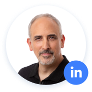Man with grey hair, black shirt, LinkedIn icon.